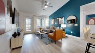 This well-appointed single-story home in San Marcos, Texas offers four bedrooms and four bathrooms across a thoughtfully designed open floor plan. A welcoming hallway lined with wood-look flooring leads seamlessly into the combined kitchen and living area, setting a bright and airy tone throughout. The living room is a standout space, featuring vaulted ceilings, a ceiling fan, and a bold teal accent wall that anchors the room with personality. Large windows invite generous natural light and frame outdoor views, complementing the open, comfortable atmosphere. The kitchen is outfitted with white shaker cabinetry, granite-style countertops, a herringbone tile backsplash, black appliances, and ample storage — all centered around a practical and stylish layout. A dedicated dining area sits adjacent, ideal for everyday meals or entertaining. Each bedroom features plush carpeting, large windows with abundant natural light, and unique accent wall colors that lend each room its own character. The four bathrooms are clean and modern, with wood-look tile flooring and soaking tubs. An in-unit laundry room houses a full-size washer and dryer. The screened-in patio, finished with teal shiplap walls and checkered flooring, offers a charming outdoor retreat with views of the surrounding greenery.
