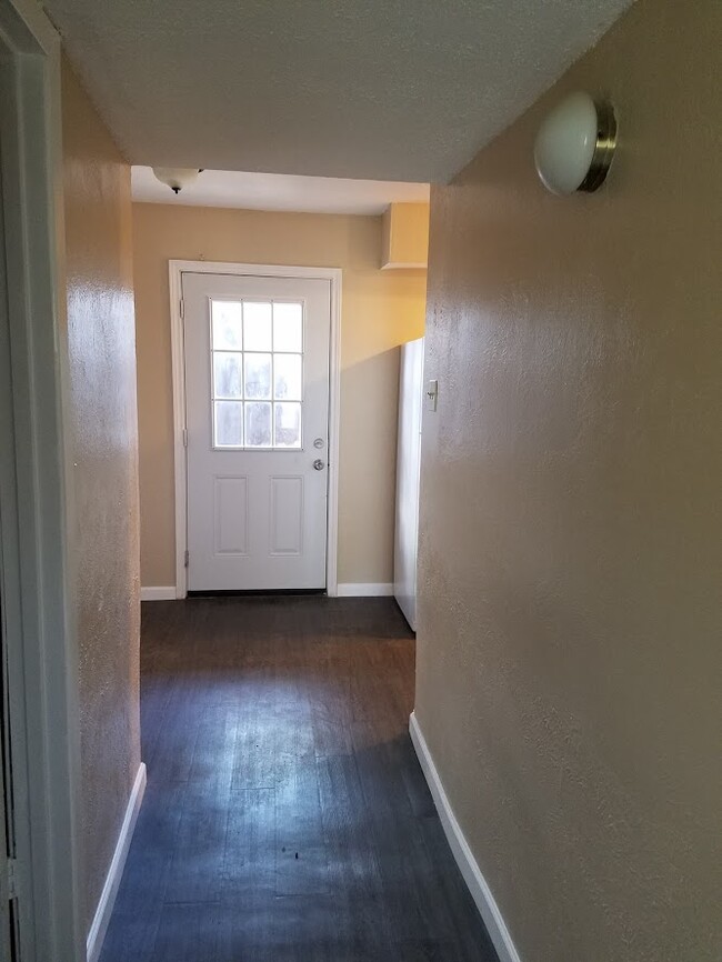 Hallway leading to the backyard door. - 228 Rolling Hills Pl