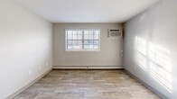 This 620 square foot apartment, located at 19 Fairway Dr in Derry, NH, offers a well-designed living space on a single floor. The layout includes two bedrooms, with the primary bedroom boasting 150 square feet of space, a full bathroom, a kitchen, and a living room.

The bathroom features a modern design with a combined tub and shower unit, a toilet, and a vanity with storage. The kitchen showcases rich, dark wood cabinetry contrasting beautifully with light-colored countertops. It's equipped with stainless steel appliances, including a freestanding range and oven, making it both functional and aesthetically pleasing.

Throughout the apartment, you'll find a mix of flooring types. Some areas feature warm, wood-look flooring, while others have neutral-toned carpeting, adding comfort and texture to the space. Large windows in the bedrooms and living areas allow for ample natural light, creating a bright and airy atmosphere.

The bedrooms offer sufficient space for comfortable living, with the larger primary bedroom providing extra room for furniture or storage. Built-in closets with sliding doors offer convenient storage solutions.

Overall, this apartment combines functionality with modern finishes, creating a cozy yet contemporary living space perfect for individuals or small families.