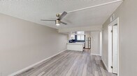 Located at 4301 North 24th Street in Phoenix, Arizona, this single-floor, 3-bedroom, 2-bathroom home offers a well-designed layout with modern finishes throughout. The open-concept living area features light gray wood-look flooring, neutral-toned walls, and a textured ceiling with a contemporary ceiling fan, creating a bright and airy atmosphere. Large sliding glass doors allow natural light to flow into the living space.

The kitchen is a standout feature, boasting white shaker-style cabinetry, light quartz countertops, and a bold navy patterned tile backsplash. A full suite of stainless steel appliances — including a refrigerator, range, microwave, and dishwasher — completes this functional and stylish space.

Each of the three bedrooms is finished with the same wood-look flooring and features generously sized sliding closets with six-panel doors, offering ample storage. The primary bedroom provides a comfortable, well-proportioned retreat.

Both bathrooms are finished in a clean, contemporary style with white cabinetry, quartz countertops, wood-look tile flooring, and brushed gold fixtures. One bathroom includes a tub/shower combo, while the other features a walk-in shower, providing versatile options for residents.