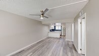 Located at 4301 North 24th Street in Phoenix, Arizona, this single-floor, 3-bedroom, 2-bathroom home offers a well-designed layout with modern finishes throughout. The open-concept living area features light gray wood-look flooring, neutral-toned walls, and a textured ceiling with a contemporary ceiling fan, creating a bright and airy atmosphere. Large sliding glass doors allow natural light to flow into the living space.

The kitchen is a standout feature, boasting white shaker-style cabinetry, light quartz countertops, and a bold navy patterned tile backsplash. A full suite of stainless steel appliances — including a refrigerator, range, microwave, and dishwasher — completes this functional and stylish space.

Each of the three bedrooms is finished with the same wood-look flooring and features generously sized sliding closets with six-panel doors, offering ample storage. The primary bedroom provides a comfortable, well-proportioned retreat.

Both bathrooms are finished in a clean, contemporary style with white cabinetry, quartz countertops, wood-look tile flooring, and brushed gold fixtures. One bathroom includes a tub/shower combo, while the other features a walk-in shower, providing versatile options for residents.