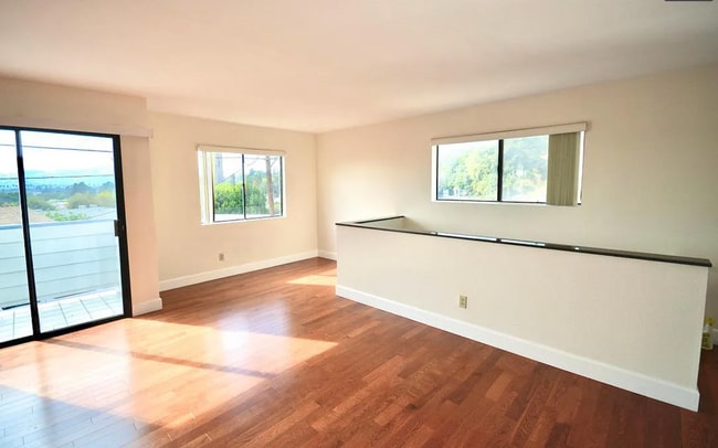 Living room with balcony access, flooded with natural light - 3161 Weldon Ave