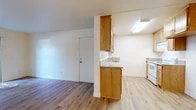 Located at 2227 E La Palma Ave in Anaheim, California, this two-bedroom, two-bathroom single-floor unit offers a practical and well-organized layout. Light wood-style flooring runs throughout the main living areas and bedrooms, creating a clean, cohesive aesthetic. The living room is bathed in natural light, courtesy of a sliding glass door that opens to an outdoor area, and is equipped with a ceiling fan for added comfort.

The kitchen features warm oak cabinetry — both upper and lower — granite-style countertops, a built-in sink, and a white range, providing a functional cooking space that flows openly into the living area. A ceiling fan overhead keeps the kitchen well-ventilated.

Both bedrooms are bright and airy, with large windows that invite ample natural light. The primary bedroom offers a comfortable footprint with a dedicated closet, while the second bedroom includes a sliding mirrored closet and similarly generous natural light. A hallway connects the main living spaces to the bedrooms and bathrooms.

The two bathrooms are finished with tile flooring, white fixtures, and oak vanity cabinetry with granite-style countertops. One bathroom features a shower-tub combination with white tile surround. The overall palette throughout is light and neutral, giving the space a clean and move-in-ready feel.