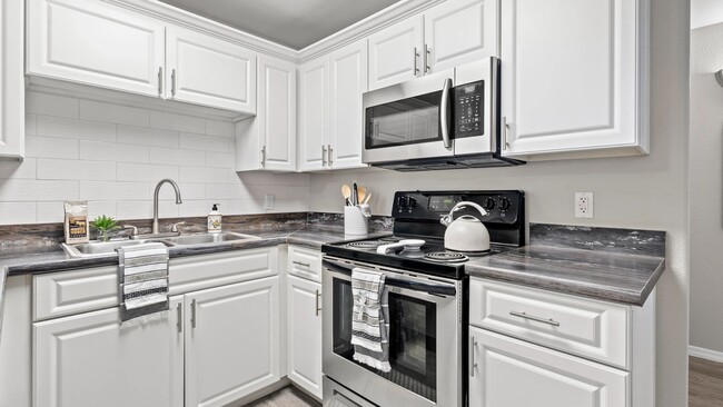 Elegance flows with designer kitchens featuring subway tile backsplash. - Luxe 1930