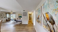 Located at 3000 Foxhill Cir in Apopka, Florida, this single-floor, 2-bedroom, 1-bathroom home offers a thoughtfully designed layout that maximizes comfort and functionality. The open living room features wood-look flooring, a ceiling fan with light fixture, and a textured ceiling, with natural light streaming in through a sliding glass door that opens to an outdoor area. The space flows naturally into a dining area, creating a versatile and welcoming common area.

The kitchen is equipped with white shaker-style cabinetry, granite-style countertops, a mosaic tile backsplash, and stainless steel appliances including a refrigerator, dishwasher, range, and microwave. A large window above the sink fills the kitchen with natural light.

The spacious primary bedroom features plush carpeting, a ceiling fan, a walk-in closet with wire shelving, and a sliding glass door providing outdoor access and natural light. The second bedroom is equally comfortable, also carpeted and outfitted with a ceiling fan and a bright window. The full bathroom includes a clean, tiled walk-in shower. Two closets throughout the home provide generous storage solutions for everyday living.