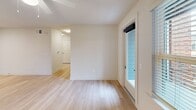 This contemporary apartment offers 860 square feet of efficiently designed living space. The open-concept layout combines the kitchen and living room, creating a spacious feel. The updated kitchen boasts dark wood cabinetry, stainless steel appliances, and granite countertops, perfect for culinary enthusiasts.

The two bedrooms are well-proportioned, with the primary bedroom measuring 170 square feet. Both bedrooms feature plush carpeting and ceiling fans for comfort. The single bathroom is modern and functional, with a granite vanity top and ample storage.

Throughout the apartment, large windows allow natural light to flood the space, enhancing the airy atmosphere. Hardwood floors in the main living areas add a touch of elegance, while the neutral color palette provides a blank canvas for personal style.

Additional features include a closet for extra storage and a glass door in one room, possibly leading to a small outdoor space. The apartment's single-story layout and thoughtful design make it an ideal choice for those seeking a contemporary, low-maintenance living solution in Columbia, SC.