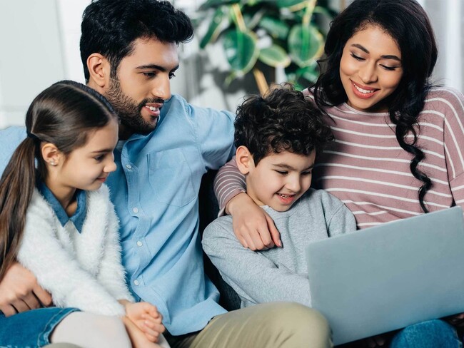 cheerful-hispanic-family-looking-at-laptop-at-home-2021-09-03-07-11-36-utc-Web - Advenir at Magnolia