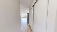 Located at 763 Woodbine Ave in Toronto's vibrant East End, this well-appointed 2-bedroom, 1-bathroom unit offers a thoughtfully designed single-floor layout. Light wood laminate flooring runs throughout, lending a clean and cohesive feel to the entire space.

The open-concept kitchen and living area forms the heart of the unit. The kitchen is outfitted with white cabinetry extending to the ceiling, white countertops, a tile backsplash, and a full suite of stainless steel appliances including a refrigerator, electric range, over-the-range microwave, and dishwasher. Large windows in the adjoining living area flood the space with natural light and frame views of the surrounding Woodbine Avenue neighbourhood.

The generously sized primary bedroom is a standout feature, offering ample room to furnish comfortably. Both bedrooms are finished with the same light wood flooring and include sliding panel closets for storage. The neutral, warm-toned walls create a calm and versatile backdrop throughout.

The bathroom is finished with light tile flooring, a modern vanity with under-sink cabinetry, a framed mirror with overhead lighting, and a full tub-shower combination. A dedicated laundry area and hallway complete the layout, adding everyday convenience to this well-rounded unit.