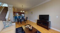 Located at 1125 Hartford Turnpike in Vernon Rockville, Connecticut, this three-floor residence is thoughtfully designed across multiple levels, offering a range of functional and comfortable living spaces.

The main level centers around an open-concept layout where the living room, dining area, and kitchen flow seamlessly together. The living room features hardwood flooring, crown molding, and a fireplace with a dark granite surround and classic white mantel. The dining area is illuminated by a decorative chandelier and connects directly to the kitchen, which is outfitted with rich cherry cabinetry, granite countertops, a breakfast bar with seating, and stainless steel appliances. A convenient half bath with tile flooring is also found on this level.

The upper level hosts the bedrooms, including a primary suite with plush carpeting, a walk-in closet, and an en-suite bathroom featuring a tub/shower combination, granite vanity, and tile flooring. An additional carpeted room with a bright window offers flexible use as a bedroom or sitting area.

The lower level presents an unfinished basement space with concrete walls and flooring, offering substantial potential for storage or future development.