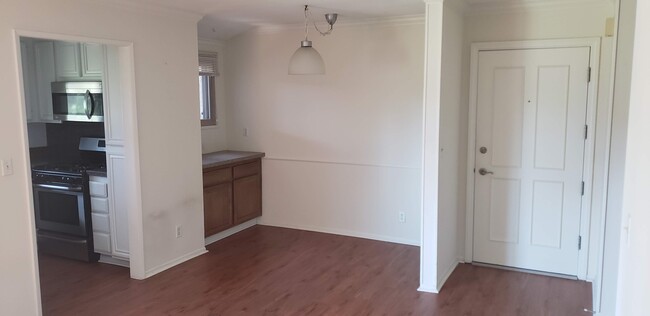 Entry, Dining (Kitchen on left) (shown with unpainted cabinets and old countertop) - 6716 Clybourn Ave