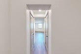 Located at 885 Westminster St in Providence, Rhode Island, this thoughtfully designed 2-bedroom, 1-bathroom residence offers a clean, modern aesthetic throughout its single-floor layout. Durable hardwood-style flooring flows seamlessly across every room, lending a warm, cohesive feel to the entire space.

The open-concept kitchen and living area serves as the heart of the home. The kitchen is outfitted with stainless steel appliances — including a refrigerator, range, microwave, and dishwasher — complemented by light wood Shaker-style cabinetry, white quartz countertops, and a classic subway tile backsplash. Recessed lighting illuminates the space effectively.

The living area is generously proportioned, with multiple windows that invite natural light and offer views of the surrounding Providence streetscape. A dedicated hallway connects the main living space to the private quarters, flanked by three closets that provide ample storage.

The primary bedroom is a comfortable size, with a window overlooking the neighborhood. The second bedroom also features windows with natural light. The full bathroom is clean and contemporary, featuring a wood-toned vanity with a white countertop, a glass-enclosed shower, a natural light window, and matching hardwood-style flooring. The overall ambiance is fresh, modern, and move-in ready.