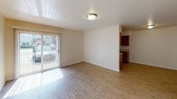 Located at 2301 W Lexington Ave in Elkhart, Indiana, this single-floor unit offers a practical and well-organized layout designed for comfortable everyday living. The entry opens into a bright living area finished with light-toned hardwood-style flooring, neutral walls, and a sliding glass door that invites natural light and provides outdoor access. Adjacent to the living space, the kitchen is efficiently designed with warm wood cabinetry, light countertops, and black appliances including an electric range, refrigerator, and dishwasher, all set over easy-care hard flooring. The bedrooms are carpeted for comfort and feature neutral walls, natural window light, and ample closet storage, including sliding double-door closets. Two full bathrooms serve the unit, each featuring a tub-shower combination, toilet, and clean white fixtures; one bathroom includes a vanity with storage. Throughout the space, consistent neutral tones and flush-mount ceiling lighting create a clean, cohesive ambiance. The layout, as visible in the floorplan view, flows logically from the main living and kitchen areas through a hallway connecting to the bedrooms and bathrooms, making the space easy to navigate and functional for daily use.