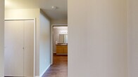 Located in Airway Heights, WA, this 2-bedroom, 1-bathroom residence offers a well-organized single-floor layout designed for comfortable everyday living. The space features a neutral color palette throughout, with clean white walls and warm beige tones that create a calm, welcoming atmosphere.

The living room is carpeted and receives natural light through a window fitted with blinds, offering views of surrounding greenery. A wall-mounted HVAC unit provides climate control. The kitchen is efficiently laid out with ample light wood cabinetry, dark laminate countertops, a coil-burner electric range with an overhead exhaust hood, and wood-look flooring that adds warmth to the space.

Both bedrooms are carpeted and feature windows with outdoor views, allowing natural light to fill each room. The primary bedroom is generously sized and includes individual climate control. The second bedroom also benefits from a bright window and shares a similarly functional design.

The full bathroom features wood-look flooring, a light wood vanity with a single sink and dark countertop, a large mirror with a lighted fixture above, and a tub-shower combination. A hallway connects the main areas of the home, and a dedicated closet provides added storage. The overall layout is practical and cohesive, suited for a range of living needs.