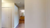 Located in Airway Heights, WA, this 2-bedroom, 1-bathroom residence offers a well-organized single-floor layout designed for comfortable everyday living. The space features a neutral color palette throughout, with clean white walls and warm beige tones that create a calm, welcoming atmosphere.

The living room is carpeted and receives natural light through a window fitted with blinds, offering views of surrounding greenery. A wall-mounted HVAC unit provides climate control. The kitchen is efficiently laid out with ample light wood cabinetry, dark laminate countertops, a coil-burner electric range with an overhead exhaust hood, and wood-look flooring that adds warmth to the space.

Both bedrooms are carpeted and feature windows with outdoor views, allowing natural light to fill each room. The primary bedroom is generously sized and includes individual climate control. The second bedroom also benefits from a bright window and shares a similarly functional design.

The full bathroom features wood-look flooring, a light wood vanity with a single sink and dark countertop, a large mirror with a lighted fixture above, and a tub-shower combination. A hallway connects the main areas of the home, and a dedicated closet provides added storage. The overall layout is practical and cohesive, suited for a range of living needs.