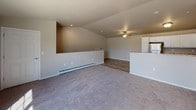 Located in New Holstein, Wisconsin, this single-floor residence offers a thoughtfully designed layout with a clean, modern aesthetic throughout. The spacious open-concept living area is finished with plush carpeting, recessed lighting, and a ceiling fan, creating a comfortable and welcoming atmosphere. A built-in wall niche adds a distinctive architectural detail, while baseboard heating ensures year-round comfort. Large windows allow natural light to fill the space and provide views of the surrounding neighborhood. A sliding door opens to an outdoor balcony, extending the living area outdoors.

The kitchen is well-equipped with white cabinetry, granite-style countertops, and a full suite of stainless steel appliances, including a refrigerator, range, microwave, and dishwasher. Wood-look flooring ties the kitchen and dining area together seamlessly.

The bedrooms are generously sized, each featuring plush carpeting, large windows with natural light, baseboard heating, and ample closet space with sliding or panel doors. The bathrooms are finished with wood-look tile flooring, white vanity cabinetry, granite-style countertops, and a walk-in shower, delivering a clean and functional design. Overall, this residence offers a bright, neutral palette and practical finishes throughout.