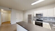 Located at 20245 North 32nd Drive in Phoenix, AZ, this single-floor, two-bedroom, one-bathroom home offers a well-designed layout with a clean, modern aesthetic throughout. Light wood-style flooring and neutral tones create a bright, cohesive atmosphere across the entire space.

The kitchen and living area share an open, connected layout. The kitchen is well-appointed with white shaker-style cabinetry, dark countertops, a grey subway tile backsplash, and a full suite of stainless steel appliances including a refrigerator, electric range, and over-the-range microwave. A skylight adds natural light to the kitchen, and a peninsula counter provides additional workspace and a natural divide between the kitchen and living area. A sliding glass door in the living area opens to a private balcony, bringing in additional natural light and outdoor views.

Both bedrooms are comfortably sized, each featuring ceiling fans, light wood-style flooring, and neutral wall tones. The primary bedroom includes a dedicated closet. The second bedroom also benefits from natural light through a window with blinds and has its own closet access.

The full bathroom is finished with a vanity featuring dark countertops, a white basin sink, a large mirror, and light wood-style flooring. The layout is efficient and cleanly finished. Two closets throughout the home provide ample storage for residents.