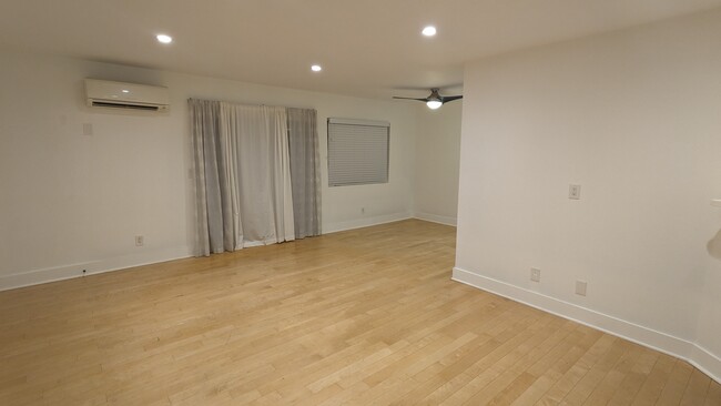 Living room dinning room, entry to balcony. - 3131 S Canfield Ave