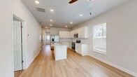 Located at 1151 Hunter Trail in Acworth, GA, this two-story, 3-bedroom, 3-bathroom home offers a clean, modern aesthetic with a bright and cohesive design throughout. The main floor is anchored by an open-concept kitchen and living area, where light hardwood flooring flows seamlessly underfoot. The kitchen is a standout feature, boasting white shaker cabinetry, a classic subway tile backsplash, granite countertops, a center island with an undermount sink, and a full suite of stainless steel appliances including a refrigerator with ice maker, range, microwave, and dishwasher. Natural light enters through multiple windows fitted with blinds, enhancing the home's airy, welcoming feel. Ceiling fans are present throughout, adding both comfort and style. The main floor also includes a dedicated laundry area for added convenience. The three bedrooms each offer hardwood flooring, ceiling fans, and generous closet space — with several rooms featuring walk-in closets. The primary bedroom includes direct access to its own bathroom. All three bathrooms are finished with white subway tile tub-shower surrounds and crisp, clean fixtures. The upper floor provides additional living space accessible via staircase, rounding out this well-appointed home.
