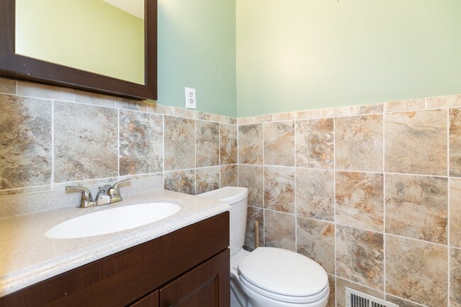 Building Photo - Spacious end-unit three-level townhome fea...