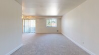 Located at 900 Macbeth Dr in Monroeville, PA, this single-story home offers a practical and well-organized layout across three bedrooms, one bathroom, and a kitchen connected by a central hallway. The spacious primary bedroom is notably generous in size, featuring soft carpeting, a ceiling fan with integrated lighting, and dual closets for ample storage. The additional two bedrooms are similarly appointed with plush carpeting, ceiling fans, individual closets, and windows with vertical blinds that allow for natural light and privacy. The living area is open and bright, benefiting from both a large window and a sliding glass door that brings in outdoor views and natural light, with neutral carpet extending throughout. The kitchen is fully equipped with warm wood cabinetry, granite-style countertops, tile flooring, and black appliances including a refrigerator, electric range with over-the-range microwave, and dishwasher. The full bathroom features a single-sink vanity with wood cabinetry and a tub/shower combination. Throughout the home, neutral tones and consistent finishes create a cohesive and functional living environment well-suited to a variety of lifestyles.