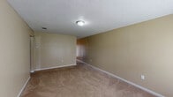 This single-floor, 2-bedroom, 1.5-bathroom residence offers a practical and comfortable layout designed for everyday living. The kitchen serves as a functional centerpiece, featuring rich dark wood cabinetry, light stone-look countertops, stainless steel appliances including a refrigerator, electric range, and dishwasher, and durable wood-look flooring that adds warmth to the space. Both bedrooms are carpeted and finished with neutral tan walls and textured ceilings, creating a cozy atmosphere. Each bedroom benefits from natural light provided by windows with blinds, and at least one bedroom includes a double-door closet for ample storage. The bathrooms are cleanly appointed, with one featuring a vanity with dark wood cabinetry, a white countertop, and tile accents. Consistent neutral tones throughout the residence contribute to a cohesive and move-in-ready feel. The layout flows efficiently from the main living area through to the kitchen and bedrooms, making good use of the available square footage. Overall, this residence provides a straightforward, comfortable living environment with practical finishes throughout.