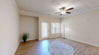 This one-bedroom, one-bathroom residence at 105 Churchill Falls Dr in Duncan, SC offers a well-organized single-floor layout designed for comfortable everyday living. The open-concept living and kitchen area serves as the heart of the home, featuring warm wood-style flooring, crown molding, and a ceiling fan that adds both style and function. Natural light streams in through blinded windows and a glass-panel door, creating a bright and welcoming atmosphere throughout.

The kitchen is equipped with warm honey-toned cabinetry, granite-look countertops, and black appliances including a range, over-the-range microwave, and dishwasher — offering ample storage and prep space for home cooking.

The bedroom is a comfortable retreat with its own window for natural light and direct access to a dedicated walk-in closet, providing generous storage. The full bathroom features a wood-toned vanity with under-sink storage, a large mirror, and a full tub-shower combination.

A dedicated laundry area with washer and dryer hookups adds everyday convenience. Consistent wood-style flooring and a neutral warm color palette flow throughout the entire space, lending a cohesive and inviting feel to every room.
