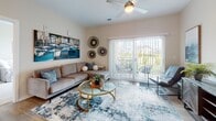 Located at 719 Lantern Walk Dr in Little River, South Carolina, this single-floor residence offers a well-designed layout that balances comfort and functionality. The kitchen is outfitted with crisp white shaker cabinetry, granite countertops, a subway tile backsplash, stainless steel appliances, and a breakfast bar island — making it an efficient and stylish space for cooking and entertaining. The living area features wood-look flooring, a ceiling fan, and large sliding glass doors that open to a private outdoor patio, filling the room with natural light and offering pleasant outdoor views. The primary bedroom is carpeted and comfortably scaled, with direct access to an en-suite bathroom featuring a walk-in shower, wood-look flooring, and nautical-inspired décor accents. A second bedroom, also carpeted, is bright and well-lit by a large window with outdoor views, and is served by a full bathroom with granite countertops, white cabinetry, and a combination tub and shower. A dedicated laundry room with wire shelving and a full-size washer and dryer adds convenience. A connecting hallway with wood-look flooring and ceiling lighting links the rooms, completing this cohesive and practical single-level home.