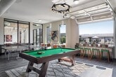 This 630-square-foot, one-bedroom, one-bathroom apartment is located at 18400 Elmendorf Drive, Unit 2-426, in Denver, Colorado 80249. The single-floor layout is thoughtfully designed to maximize space and functionality. The open-concept kitchen is a standout feature, showcasing dark espresso cabinetry, a white subway tile backsplash, stainless steel appliances including a refrigerator, range, and microwave, and a large granite-topped island with an undermount sink — ideal for both cooking and casual dining. Warm hardwood-style flooring extends throughout the unit, lending a cohesive and contemporary feel. The 140-square-foot primary bedroom offers a ceiling fan, a tray ceiling detail, a dedicated closet, and a large window that fills the room with natural light. The bathroom features matching dark cabinetry, a granite vanity countertop, and modern brushed-nickel fixtures, maintaining the same refined aesthetic as the rest of the unit. Neutral gray walls throughout create a calm, move-in-ready backdrop. Recessed lighting in the kitchen and ceiling fans in the living and bedroom areas add comfort and practicality to this well-appointed Denver apartment.