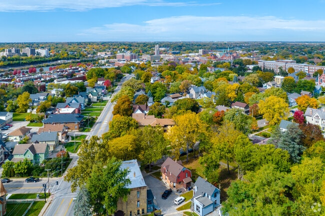 Aerial view of historic district with Elgin downtown and Fox River in the background.
