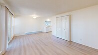 Located in Lakewood, WA, this 2-bedroom, 1-bathroom unit offers a well-organized single-floor layout designed for functional everyday living. The living room is bright and open, featuring light luxury vinyl plank flooring, crisp white walls, a textured ceiling, and large windows alongside a sliding glass door that floods the space with natural light and provides views of the surrounding greenery. A baseboard heating system runs throughout the main living areas for consistent warmth.

The kitchen is efficiently laid out and includes white cabinetry, a dishwasher, and a window overlooking the outdoors. A generous closet with double panel doors adds convenient storage to the main living area.

Both bedrooms are carpeted and maintain a clean, neutral palette. Each room is equipped with baseboard heating, a closet with sliding doors, and windows that invite natural light. The bedrooms offer a quiet, restful atmosphere well-suited for relaxation.

The bathroom features a full tub and shower combination, a vanity with cabinet storage, a toilet, and light vinyl flooring that ties into the home's cohesive, clean aesthetic. Flush-mount lighting throughout keeps each room well-illuminated. Overall, this unit presents a tidy, move-in-ready space with a straightforward and practical design.