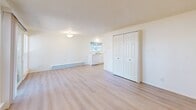 Located in Lakewood, WA, this 2-bedroom, 1-bathroom unit offers a well-organized single-floor layout designed for functional everyday living. The living room is bright and open, featuring light luxury vinyl plank flooring, crisp white walls, a textured ceiling, and large windows alongside a sliding glass door that floods the space with natural light and provides views of the surrounding greenery. A baseboard heating system runs throughout the main living areas for consistent warmth.

The kitchen is efficiently laid out and includes white cabinetry, a dishwasher, and a window overlooking the outdoors. A generous closet with double panel doors adds convenient storage to the main living area.

Both bedrooms are carpeted and maintain a clean, neutral palette. Each room is equipped with baseboard heating, a closet with sliding doors, and windows that invite natural light. The bedrooms offer a quiet, restful atmosphere well-suited for relaxation.

The bathroom features a full tub and shower combination, a vanity with cabinet storage, a toilet, and light vinyl flooring that ties into the home's cohesive, clean aesthetic. Flush-mount lighting throughout keeps each room well-illuminated. Overall, this unit presents a tidy, move-in-ready space with a straightforward and practical design.