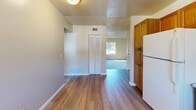 Located at 1424 Alamo Ct in Vacaville, California, this single-floor, 2-bedroom, 1-bathroom home offers a practical and comfortable layout. The interior is finished with a combination of plush carpeting in the living and bedroom areas and durable hardwood-style flooring in the kitchen and hallway spaces.

The kitchen is well-equipped, featuring warm oak cabinetry with glass-accented upper doors, stone-look countertops, a full suite of white appliances including a gas range, dishwasher, and refrigerator, and a window that brings in natural light. An adjacent pantry provides additional storage.

Both bedrooms are carpeted and include ceiling fans with light fixtures and windows overlooking the surrounding neighborhood. The primary bedroom features a mirrored sliding closet door. A hallway connects the bedrooms to the shared full bathroom, which is outfitted with wood-look flooring, a vanity, and a tub-shower combination with sliding glass doors.

The living room offers a bright, open feel with a large window and textured ceiling. Multiple closets throughout the home ensure ample storage. A utility room rounds out the functional layout of this well-organized Vacaville residence.