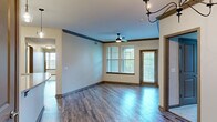 Located at 5400 Chenonceau Blvd in Little Rock, Arkansas, this single-story, 4-bedroom, 2-bathroom home offers a well-designed layout with a comfortable, functional flow throughout. The open living and dining area features rich hardwood-style flooring, crown molding with dark wood accents, a ceiling fan, and an elegant chandelier, all complemented by abundant natural light streaming through multiple windows with views of surrounding greenery. A private entry door in the living area adds convenience and accessibility. The kitchen is well-appointed with rich dark wood cabinetry, granite-style countertops, stainless steel appliances, and a central island — ideal for both cooking and entertaining. The four bedrooms offer a mix of hardwood-style flooring and plush carpeting, each filled with natural light from generously sized windows. The spacious primary bedroom includes a ceiling fan, walk-in closet, and en-suite access. The bathrooms feature tile flooring, granite-topped vanities, and a tub-shower combination. A dedicated laundry room with full-size washer and dryer hookups and additional storage adds practical everyday convenience. With consistent finishes, thoughtful details, and a warm ambiance throughout, this home presents a comfortable and inviting living environment.