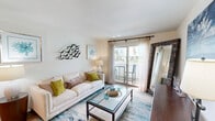 Located in Galveston, TX, this thoughtfully designed one-bedroom, one-bathroom residence offers a functional and welcoming layout across a single floor. The living room serves as the heart of the home, featuring wood-style flooring, a coastal-inspired aesthetic, and a sliding glass door that opens to a private balcony, filling the space with abundant natural light and outdoor views. A dedicated dining area flows seamlessly from the living space, creating an open and connected feel. The kitchen is efficiently appointed with rich wood cabinetry, a double-basin sink, laminate countertops, and stainless steel appliances including a refrigerator and dishwasher, complemented by a window that brings in additional natural light. The bedroom is a serene retreat, complete with plush carpeting, a ceiling fan, a large window overlooking the outdoors, and access to a walk-in closet. A second closet provides additional storage throughout the unit. The bathroom features a combined tub and shower, a wood-toned vanity with ample counter space, and overhead cabinetry for storage. An in-unit laundry area adds everyday convenience, completing this well-rounded coastal Galveston residence.