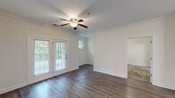 Located at 2118 Silvercrest Dr in Myrtle Beach, SC, this well-designed 2-bedroom, 2-bathroom single-floor home offers a comfortable and functional layout. The living room serves as a welcoming centerpiece, showcasing rich hardwood-style flooring, elegant crown molding, and a ceiling fan with light. French doors flood the space with natural light and provide outdoor views, while a distinctive octagonal accent window adds architectural character. Adjacent to the living area, the dining room features coordinating hardwood-style floors, chair rail molding, and a stylish pendant light fixture. The galley-style kitchen is well-equipped with rich dark wood cabinetry, granite-look countertops, stainless steel appliances, and a direct connection to the utility room. Both bedrooms are carpeted for comfort and include ceiling fans and windows that bring in natural light. The primary bedroom is generously sized with its own closet access. The bathrooms are finished with dark wood vanities, solid-surface countertops, large mirrors, and hardwood-style flooring. A dedicated utility room and hallway with closets round out the practical layout of this inviting Myrtle Beach home.