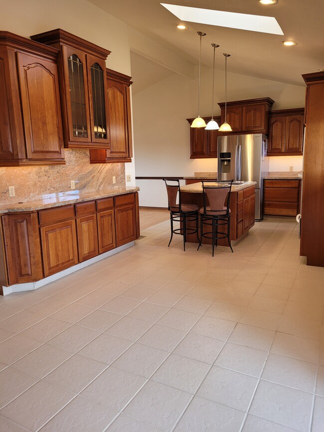 Renovated kitchen with granite and new stainless appliances. - 9637 W Ohio Ave