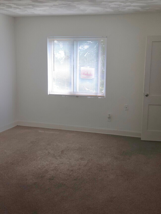 Large living room with carpet - 204 Oklahoma Ave NE