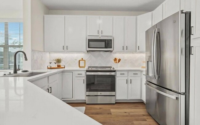 Expansive Kitchen Featuring Stainless Steel Appliances and Ample Storage - The Maggie