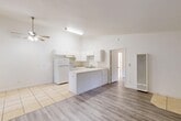 Located at 2770 Eaton Rd in Chico, California, this single-story, one-bedroom, one-bathroom unit offers a thoughtfully arranged floor plan that maximizes its compact footprint. The open-concept great room and dining area flow seamlessly together, finished with light-toned laminate wood flooring and a ceiling fan that enhances air circulation throughout the main living space. A sliding glass door connects the great room to a private patio, allowing natural light to filter in and providing easy outdoor access.

The kitchen is defined by a peninsula with a tiled countertop, white cabinetry, a white refrigerator, and a range — all set atop classic ceramic tile flooring. The kitchen opens directly to the dining and living areas, making the space feel connected and functional.

The bedroom is a comfortable, well-proportioned room featuring the same light laminate flooring, a ceiling fan, and a window with outdoor views of the surrounding neighborhood greenery. A dedicated closet provides convenient storage.

The bathroom is clean and straightforward, featuring tile flooring, a vanity, a bathtub with shower, and bright white walls. Throughout the unit, the consistent white walls and neutral palette create a bright, airy ambiance well-suited to Chico's warm Central Valley climate.