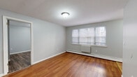 Located at 205 Sigourney St in Hartford, CT, this compact one-bedroom, one-bathroom unit offers a practical and well-organized layout across a single floor. The living room is a bright, open space featuring warm wood-look flooring, soft gray walls, and a multi-pane window that allows natural light to fill the room. Baseboard heating runs along the exterior walls, providing efficient climate control. The layout flows naturally from the living area toward the kitchen and bedroom.

The kitchen is equipped with warm-toned wooden cabinetry — both upper and lower — paired with a granite-style laminate countertop and a stainless steel sink. Terracotta-toned tile flooring grounds the space and provides a practical, easy-to-clean surface.

The bedroom offers a comfortable and private retreat, featuring darker wood-look flooring, soft gray walls, a window with natural light, and a built-in closet with shelving for storage. The baseboard heating continues here as well, ensuring year-round comfort.

The bathroom includes a full tub-shower combination with white tile surround, a toilet, and classic tilework along the lower walls, offering a clean and functional design.

Throughout the unit, the consistent use of neutral gray tones and wood-look flooring creates a cohesive, understated aesthetic well-suited for comfortable everyday living.