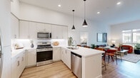 Located at 1800 Santa Carolina Rd in Chula Vista, CA, this well-appointed 2-bedroom, 1-bathroom residence offers a thoughtfully designed single-level layout with modern finishes throughout. The open-concept kitchen and living area serves as the heart of the home, featuring crisp white cabinetry, a white quartz peninsula with pendant lighting, stainless steel appliances including a gas range and dishwasher, and light wood-style flooring that flows seamlessly into the living room. The bright living area benefits from large windows and a glass door opening to a private balcony, which overlooks a landscaped courtyard — an ideal space for outdoor dining. The spacious primary bedroom provides generous proportions, plush carpeting, and a large window with views of the surrounding community. The second bedroom is equally comfortable with soft carpeting and warm ambient lighting. The bathroom features a clean, contemporary design with a white quartz vanity, wood-toned cabinetry, built-in open shelving, and a shower-tub combination. A dedicated walk-in closet with built-in shelving and hanging rods offers excellent storage. The overall ambiance is light, airy, and modern — ideal for those seeking a comfortable, stylish home in a vibrant Southern California community.
