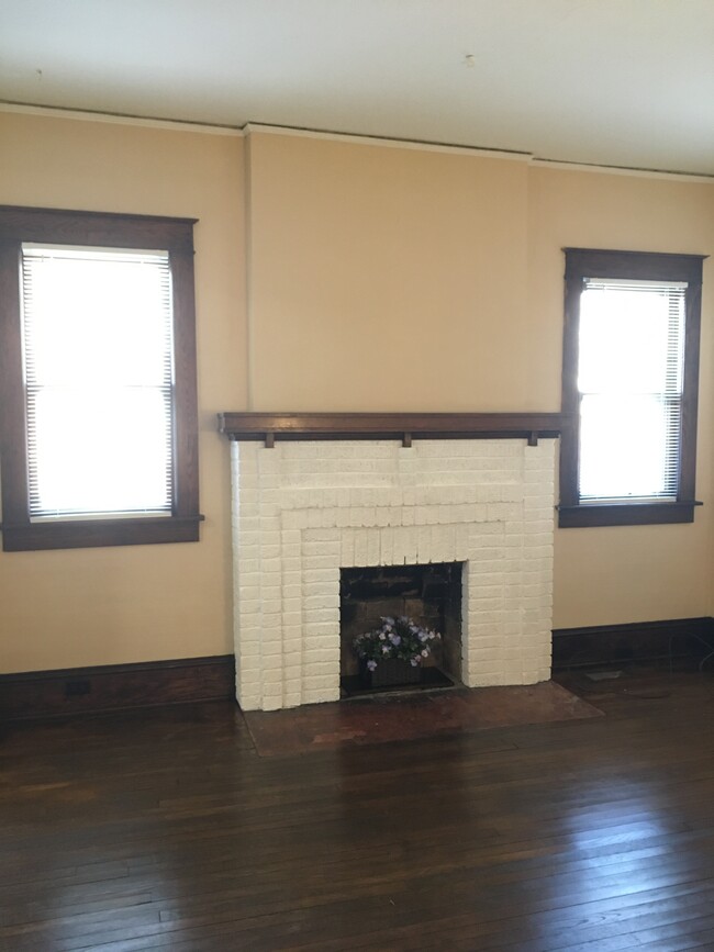 Living room area. 1920 Original Hardwood Floors just refinished. Decorative fireplace - 400 W Maple St