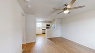 Located at 3450 Barker Cypress Rd in Houston, TX, this 2-bedroom, 1-bathroom single-story home offers a clean, modern interior with a practical and efficient layout. The open-concept living, dining, and kitchen area forms the heart of the home, featuring warm light wood flooring and a ceiling fan that enhances airflow and comfort. Natural light filters in through multiple windows fitted with blinds throughout the space.

The kitchen is well-appointed with white cabinetry, marble-style countertops, a peninsula for additional prep space, and a full suite of stainless steel appliances including a refrigerator, electric range, microwave, and dishwasher. Track lighting and a window above the sink add both function and brightness.

Both bedrooms are carpeted and bathed in natural light. The spacious primary bedroom features hardwood-style flooring, a ceiling fan, and a large window with exterior views. The secondary bedrooms include closet access and neutral wall tones throughout.

The bathroom offers a clean, contemporary finish with a marble-style vanity top, white cabinetry, wood-look flooring, and a full tub-shower combo. Additional conveniences include a dedicated laundry area, pantry, and hallway connecting the rooms seamlessly.
