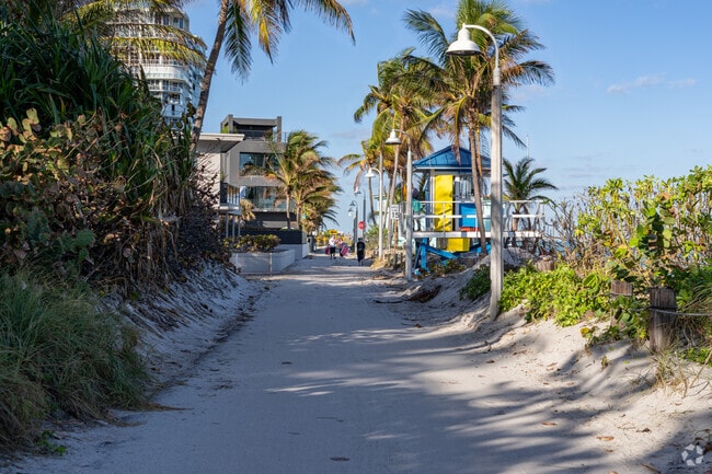 Small streets line Dania Beach covered in sand from how close they are to the beach.