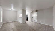 This 2-bedroom, 1-bathroom unit at 2730 Lafferty Rd in Pasadena, TX offers a well-organized, single-floor layout designed for comfortable everyday living. The open-concept living room and kitchen area provides a seamless flow between spaces, with durable wood-look flooring in the kitchen and entryway transitioning to plush neutral carpet in the living and bedroom areas. The galley-style kitchen is thoughtfully appointed with crisp white cabinetry, granite-style countertops, a stainless steel double-basin sink, a dishwasher, an electric range, and a full-size refrigerator, offering ample storage and prep space. The spacious primary bedroom features soft carpeting, a window with natural light, and a dedicated closet with built-in shelving and a hanging rod for organized storage. The second bedroom is similarly appointed with carpet flooring, a window overlooking the surroundings, and its own closet with double doors. The full bathroom includes a granite-top vanity with white cabinetry, a mirror, wood-look tile flooring, and a full tub-shower combination. Neutral tones and clean finishes throughout lend the space a bright, move-in-ready aesthetic.