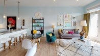 Located at 650 E Stonewall St. in Charlotte, NC, this single-floor residence offers a thoughtfully designed layout with contemporary finishes throughout. The open-concept living and dining area is bathed in natural light, featuring soft blue-gray walls, light wood-style flooring, and French doors that open to an outdoor patio with views of the surrounding neighborhood. The kitchen is outfitted with crisp white shaker cabinetry extending to the ceiling, stainless steel appliances including a French door refrigerator, electric range, and built-in microwave, complemented by a neutral tile backsplash and ample counter space. The bedrooms offer a restful retreat, each with large windows that invite natural light, light wood flooring, and generous closet space — one bedroom features a walk-in closet. The bathroom is well-appointed with a combination tub and shower surrounded by floor-to-ceiling tile, a wide vanity with shaker-style cabinetry, a large mirror, and warm lighting. Light wood flooring flows consistently throughout the residence, unifying the space with a warm, cohesive aesthetic. The overall ambiance is modern yet welcoming, combining clean architectural lines with an inviting, livable design.