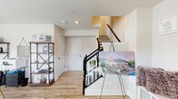 Located at 3101 Runnel Ln in Laurel, MD, this three-story townhome offers a well-organized layout across three distinct levels. The entry floor provides a welcoming foyer with light hardwood-style flooring, a coat closet, and a staircase with classic black balusters leading to the main living area.

The main level hosts a bright, open-concept kitchen and living space bathed in natural light from large windows. The kitchen features white shaker cabinetry with gold hardware, a quartz-topped center island with bar seating, stainless steel appliances, and recessed lighting — all flowing seamlessly into a dining area and living room with views of the surrounding neighborhood.

The upper floors accommodate three bedrooms and three full bathrooms. The primary bedroom offers plush carpeting, a walk-in closet, and a dedicated en-suite bathroom with a glass-enclosed tile shower, white vanity, and gold-accented fixtures. Additional bedrooms are well-proportioned with built-in closets and soft carpet underfoot. Secondary bathrooms include a tiled tub-shower combination and white vanities with matching gold hardware.

Throughout, the home maintains a clean, neutral palette with consistent light wood flooring on common areas and carpet in bedrooms, creating a cohesive and modern aesthetic suitable for everyday living.