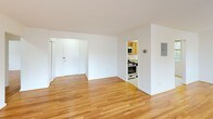 Located in the desirable Chevy Chase neighborhood of Maryland, this single-floor residence at 4743 Bradley Blvd offers a clean, well-maintained living environment with a bright and functional layout. Warm hardwood flooring extends throughout the main living areas and bedrooms, reflecting natural light and lending a sense of continuity across the space.

The expansive living area is bathed in natural light from large windows that offer views of the surrounding neighborhood. The open layout flows seamlessly toward the kitchen, which is equipped with oak cabinetry, granite countertops, stainless steel appliances including a gas range, built-in microwave, dishwasher, and refrigerator—providing ample storage and functionality.

The bedrooms feature the same hardwood flooring and are outfitted with generous closet space, including a sliding-door closet with built-in shelving and rod, as well as additional door access. Multiple windows in the bedrooms allow for excellent natural light and views of the greenery outside.

The bathroom presents a classic aesthetic with white subway tile accented by a bold black border, a full soaking tub with shower, a window for natural ventilation, and a clean, timeless finish. The overall ambiance of the residence is bright, neutral, and move-in ready.