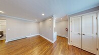 Located at 340 Park Street, Unit 16A in Hackensack, NJ, this well-appointed one-bedroom, one-bathroom residence offers a thoughtfully designed single-floor layout. Rich hardwood flooring flows throughout the entire unit, complemented by crisp crown molding and neutral warm-gray walls that create a cohesive, move-in-ready aesthetic. Recessed lighting brightens the open living area, which features baseboard heating and a front entry door with a decorative transom window that invites natural light. The bedroom is a comfortable size and includes a ceiling fan, a window with outdoor views, and direct access to a well-organized closet with built-in shelving and hanging rods. Two additional closets provide generous storage throughout the unit. The bathroom is finished with clean white subway-style tile, a tasteful mosaic accent border, a combination soaking tub and shower, and a dark wood vanity with ample cabinet space and a mirrored medicine cabinet. The kitchen connects seamlessly to the living area via a partial half-wall. A dedicated in-unit laundry area adds everyday convenience. The unit also includes a hallway that connects the primary spaces efficiently, rounding out a practical and attractive floor plan.