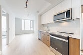 Located at 300 Miwate Pvt in Ottawa, this efficiently designed one-bedroom, one-bathroom unit offers a clean, contemporary aesthetic throughout. The open-concept layout connects the kitchen and living area seamlessly, maximizing the use of space. Light wood-tone flooring runs throughout, creating a warm, cohesive feel that complements the bright white walls and modern finishes.

The kitchen is a functional highlight, featuring two-toned cabinetry with warm wood lower cabinets and crisp white upper cabinets, a marble-effect backsplash, and a full suite of stainless steel Whirlpool appliances including a range, over-the-range microwave, dishwasher, and refrigerator. A single-basin sink with a contemporary faucet completes the thoughtful design. Track lighting illuminates the open living area, which benefits from a large window that draws in natural light.

The bedroom is a calm, minimal space with its own access to a private balcony through a floor-to-ceiling sliding glass door, offering an airy extension of the living space. A built-in closet with sliding doors provides practical storage.

The bathroom features large-format tile wall surrounds in the tub/shower combo, warm beige floor tiles, a wood-toned vanity, and a clean white countertop, maintaining the unit's modern and cohesive design language throughout.